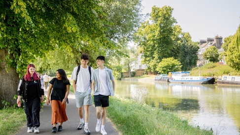 A group of University of Cambridge students spending time with friends and walking in a park by the river in central Cambridge