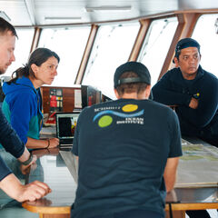Dr Laura Cimoli discusses glider operations with the bridge and deck teams. Credit to Alex Ingle/Schmidt Ocean Institute.