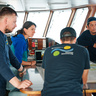 Dr Laura Cimoli discusses glider operations with the bridge and deck teams. Credit to Alex Ingle/Schmidt Ocean Institute.