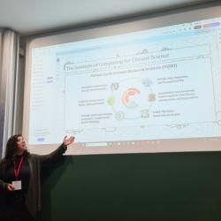 2025 ICCS intern Alison Spadaro gives a presentation in front of a big screen
